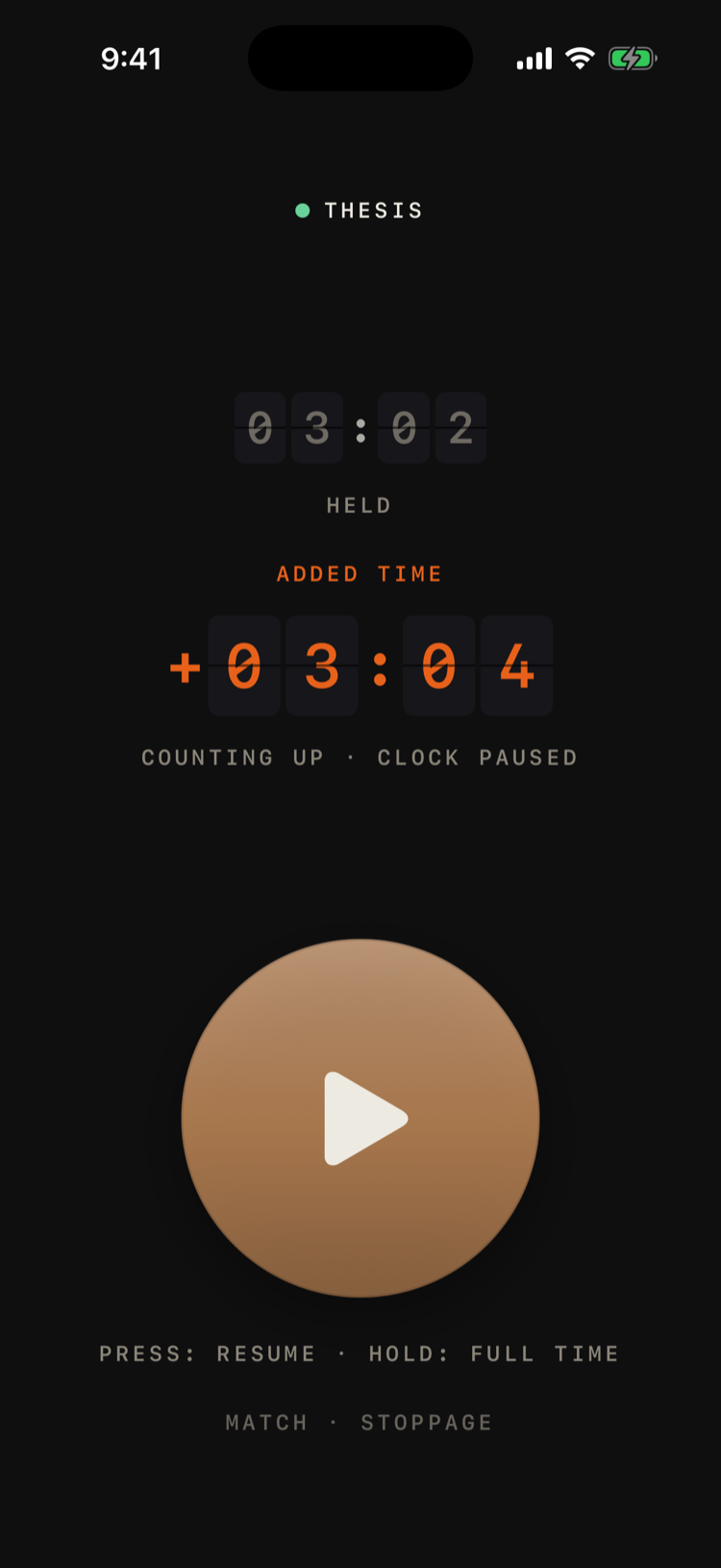 The same Match screen held in stoppage: the main clock greyed at 03:02 under the word HELD, and beneath it “ADDED TIME” with +03:04 counting up in orange split-flap digits. The whistle disc has dimmed to a play symbol.